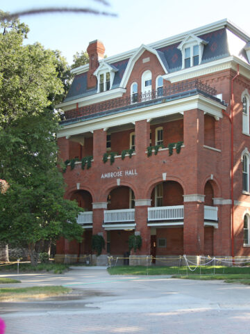 Old red brick university building with hanging gardens.