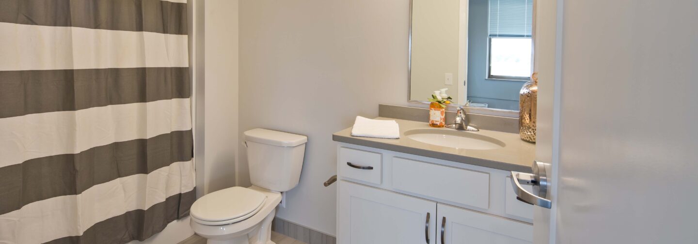 This image displays a modern bathroom at Hershey Lofts in Muscatine, Iowa